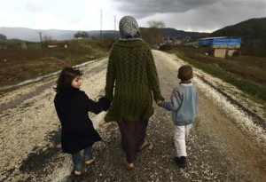 Sawssan Abdelwahab, who fled Idlib in Syria, walks with her children outside a refugee camp near the Turkish-Syrian border. (Photo: REUTERS/Zohra Bensemra)